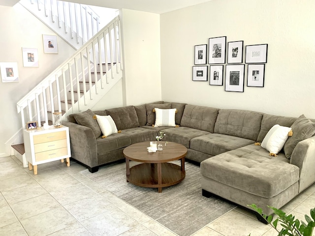 living room with stairs and tile patterned flooring