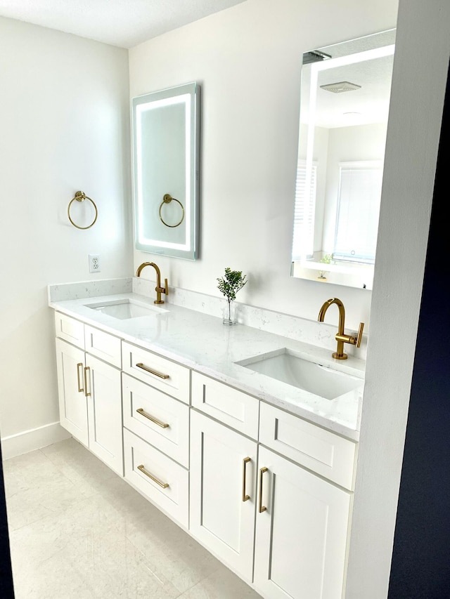 bathroom featuring a sink and double vanity