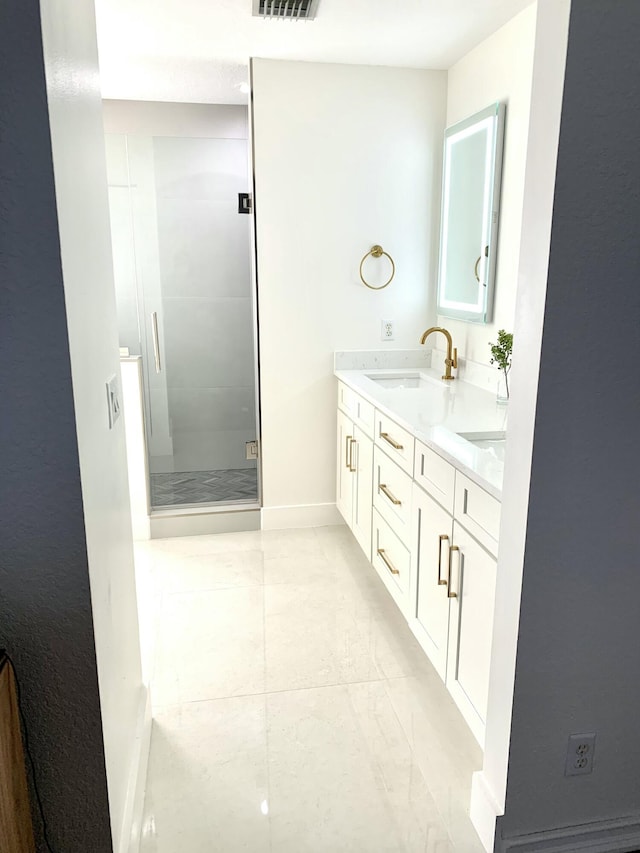 bathroom with a sink, double vanity, marble finish floor, baseboards, and a stall shower