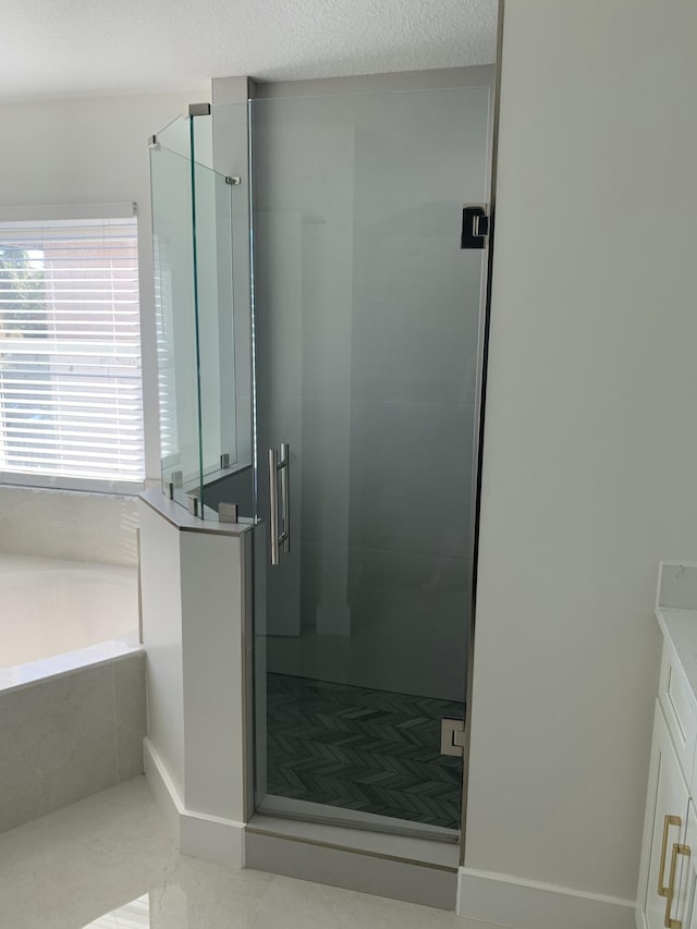 bathroom with vanity, tile patterned floors, a bath, and a stall shower
