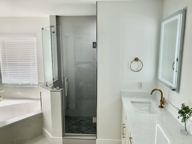 bathroom with vanity, a stall shower, and a garden tub
