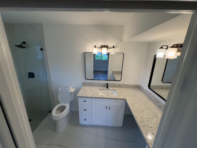 bathroom with marble finish floor, toilet, vanity, and a marble finish shower