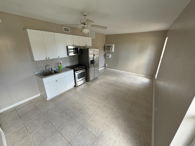 kitchen with an AC wall unit, a sink, light tile patterned flooring, appliances with stainless steel finishes, and ceiling fan