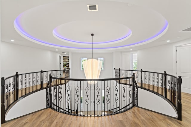 10343 S Barnsley Dr, Parkland, FL 33076 - hall with an upstairs landing, wood finished floors, a tray ceiling, and recessed lighting