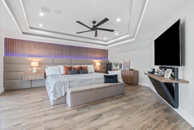 10343 S Barnsley Dr, Parkland, FL 33076 - bedroom featuring a raised ceiling, light wood-type flooring, recessed lighting, and ceiling fan