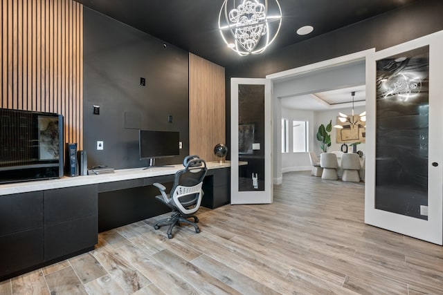 10343 S Barnsley Dr, Parkland, FL 33076 - office space with a chandelier, light wood-type flooring, and built in desk
