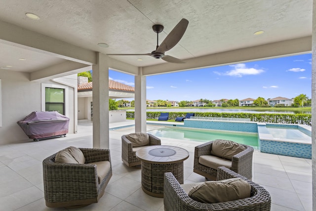 10343 S Barnsley Dr, Parkland, FL 33076 - view of patio featuring a ceiling fan, an outdoor pool, a grill, a hot tub, and a water view