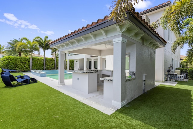 10343 S Barnsley Dr, Parkland, FL 33076 - view of patio / terrace featuring an outdoor kitchen, a pool with connected hot tub, and a bar