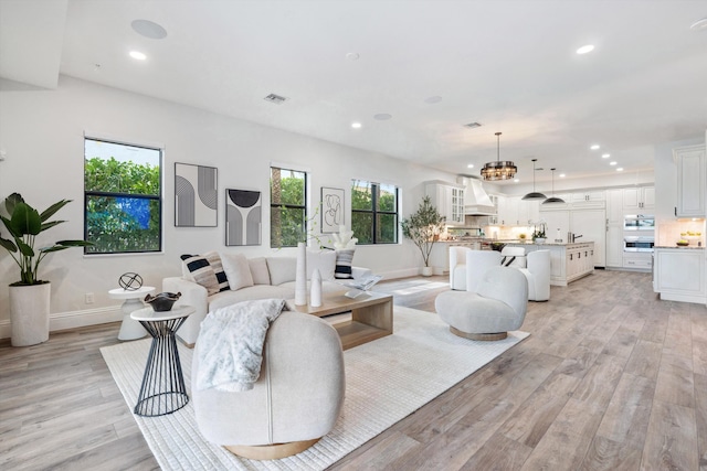 10343 S Barnsley Dr, Parkland, FL 33076 - living room with recessed lighting, light wood finished floors, and a chandelier