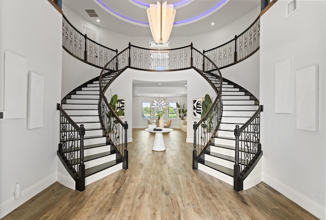 10343 S Barnsley Dr, Parkland, FL 33076 - entrance foyer featuring a chandelier, a towering ceiling, stairs, wood finished floors, and recessed lighting