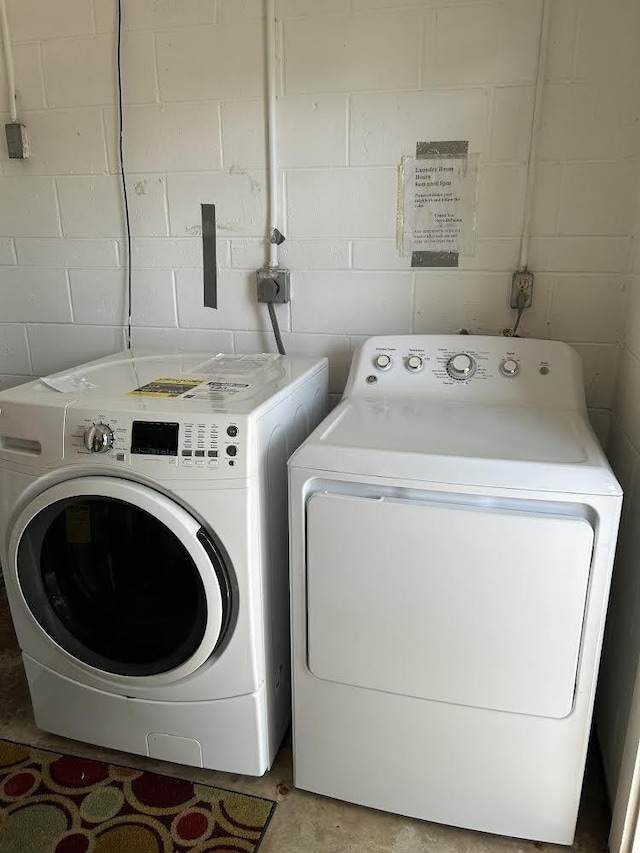 903 Savannas Point Dr Unit D, Fort Pierce, FL 34982 - clothes washing area featuring concrete block wall, washer and dryer, and laundry area