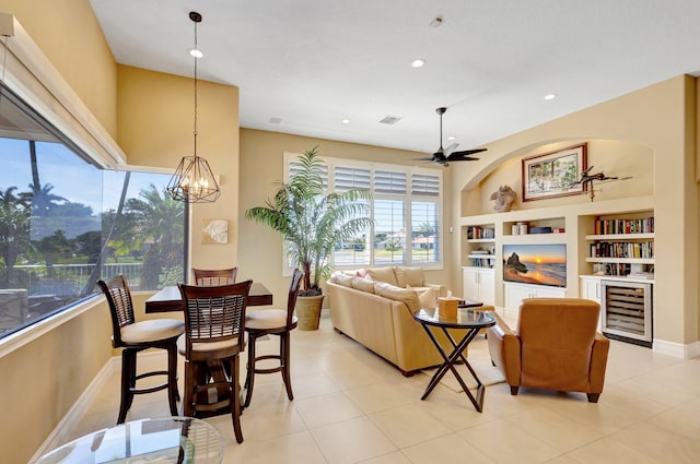 living room with visible vents, built in features, wine cooler, recessed lighting, and ceiling fan with notable chandelier