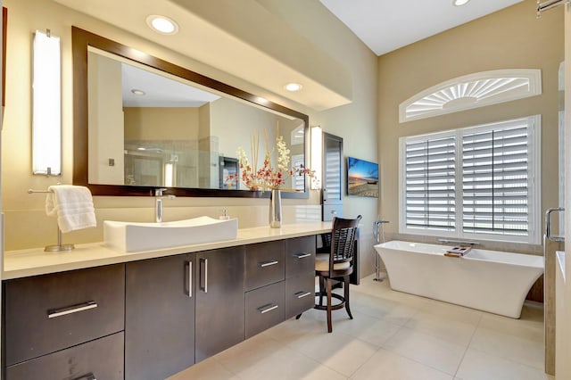 bathroom featuring vanity, recessed lighting, a freestanding bath, tile patterned floors, and a shower stall