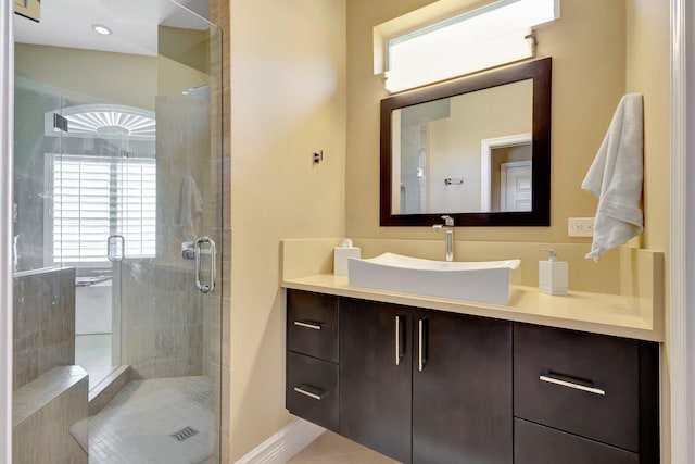 bathroom with tile patterned floors, a shower stall, and vanity