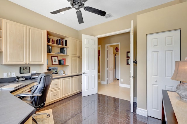 office area featuring baseboards, a ceiling fan, built in desk, and visible vents