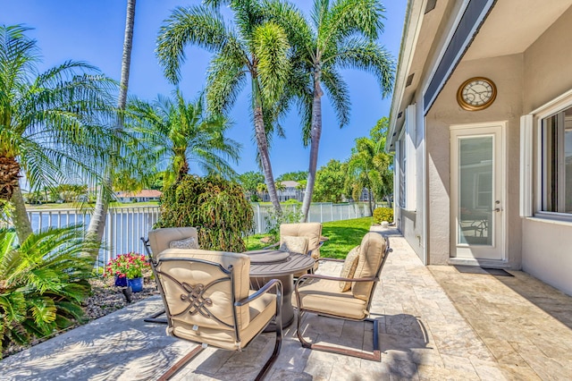 view of patio featuring a fenced backyard and a water view
