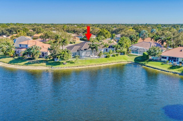 drone / aerial view featuring a water view and a residential view