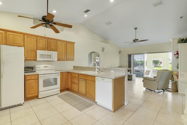 kitchen featuring a sink, arched walkways, white appliances, a peninsula, and ceiling fan