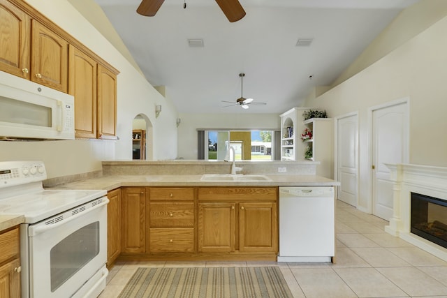 kitchen featuring lofted ceiling, a ceiling fan, a sink, and white appliances