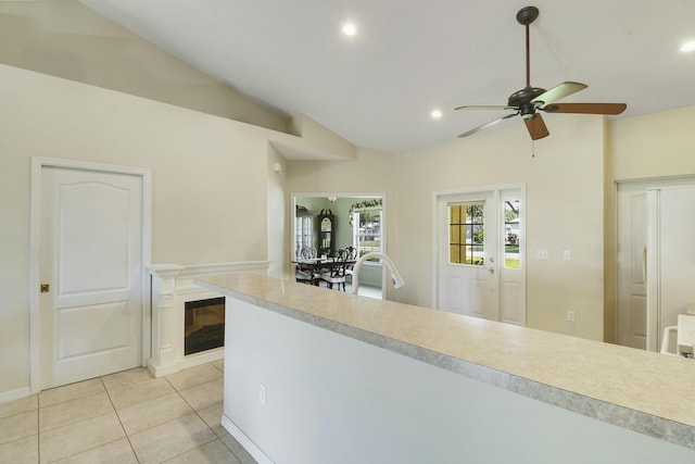 kitchen with light tile patterned floors, ceiling fan, light countertops, lofted ceiling, and recessed lighting