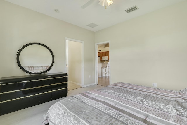 bedroom featuring tile patterned floors, a ceiling fan, visible vents, and baseboards
