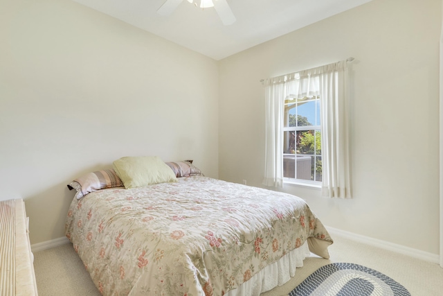 carpeted bedroom featuring ceiling fan and baseboards