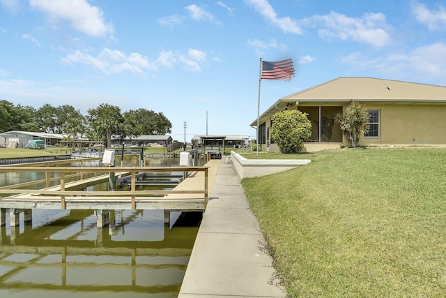 dock area featuring a lawn, a water view, and boat lift