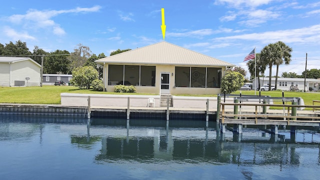 view of dock with a yard, central air condition unit, and a water view