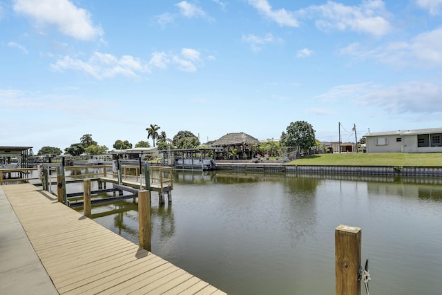 dock area with boat lift and a water view
