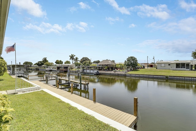 dock area with a yard, a water view, and boat lift