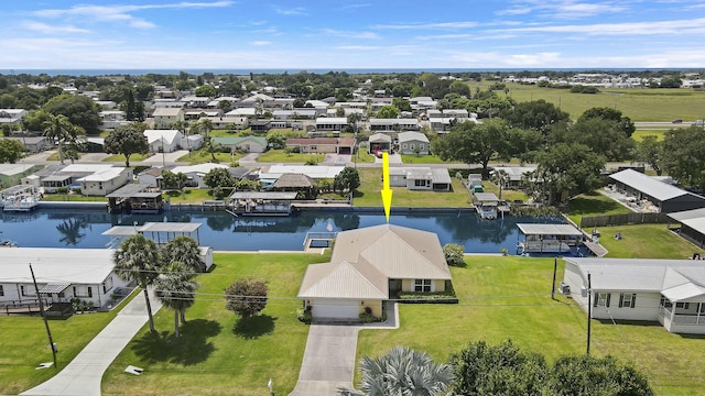 drone / aerial view featuring a residential view and a water view