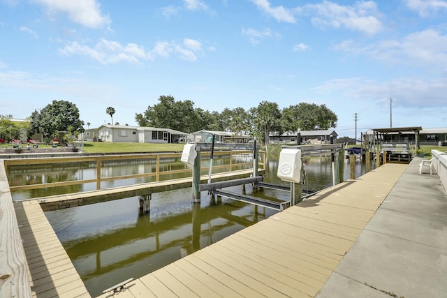 view of dock featuring boat lift and a water view