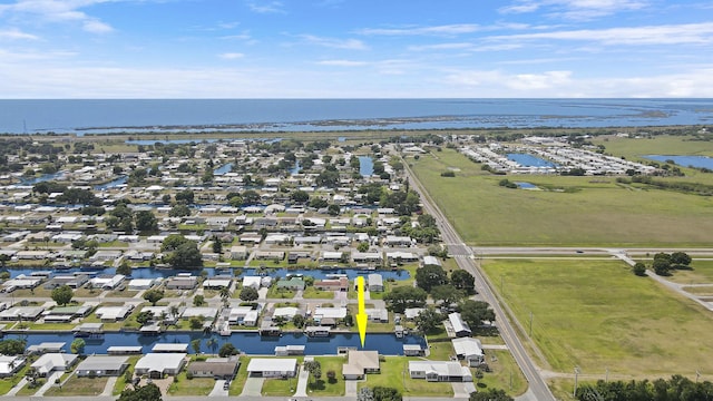drone / aerial view featuring a residential view and a water view