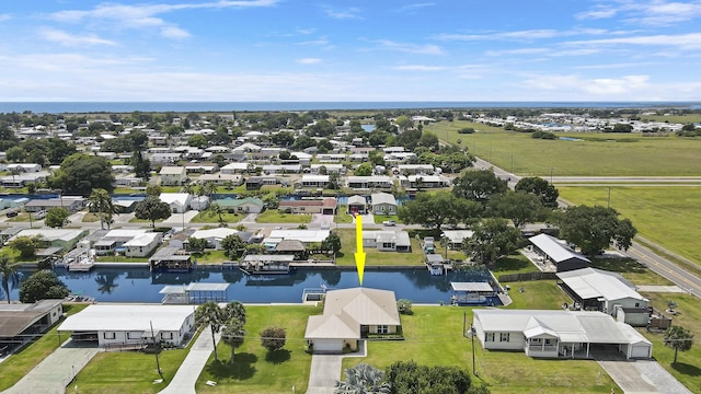 drone / aerial view featuring a residential view and a water view