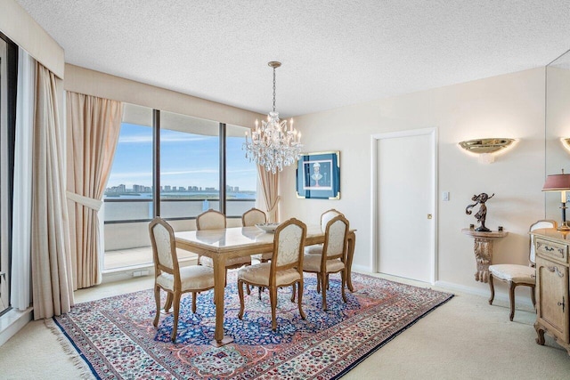 100 Lakeshore Dr Unit 1557, North Palm Beach, FL 33408 - carpeted dining room featuring a textured ceiling, an inviting chandelier, and a water view