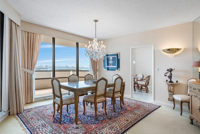 100 Lakeshore Dr Unit 1557, North Palm Beach, FL 33408 - dining area with carpet flooring, a textured ceiling, and a notable chandelier