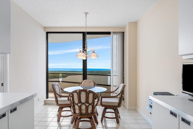 100 Lakeshore Dr Unit 1557, North Palm Beach, FL 33408 - dining space featuring light tile patterned floors, a textured ceiling, an inviting chandelier, and baseboards