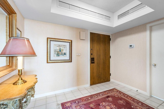 100 Lakeshore Dr Unit 1557, North Palm Beach, FL 33408 - entryway featuring light tile patterned flooring, a textured ceiling, and baseboards