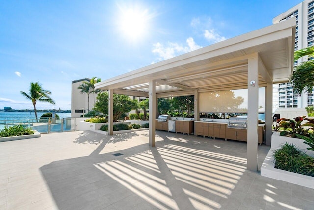 100 Lakeshore Dr Unit 1557, North Palm Beach, FL 33408 - view of patio / terrace with area for grilling, a water view, and grilling area