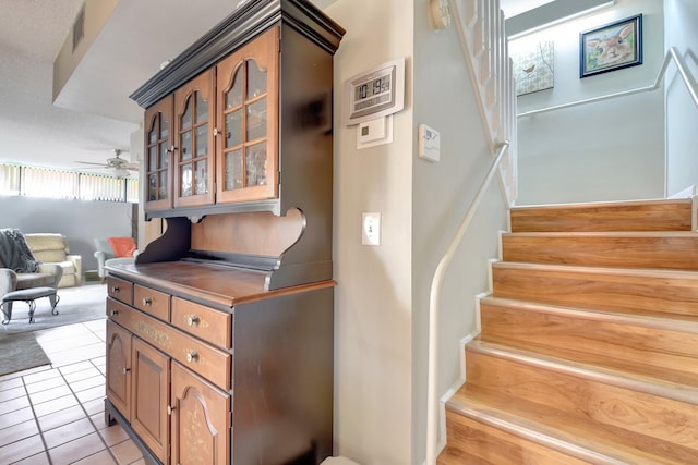3718 Victoria Dr, West Palm Beach, FL 33406 - staircase featuring ceiling fan and tile patterned floors