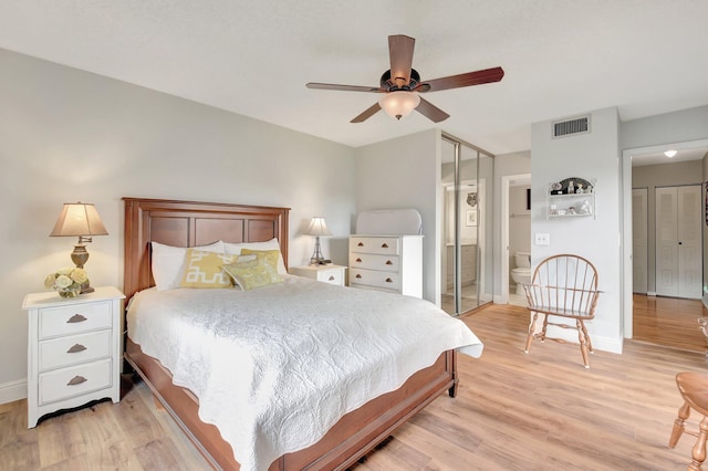 3718 Victoria Dr, West Palm Beach, FL 33406 - bedroom with light wood finished floors, baseboards, ensuite bathroom, and ceiling fan