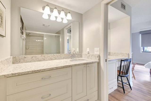 3718 Victoria Dr, West Palm Beach, FL 33406 - full bathroom featuring wood finished floors, a shower stall, and vanity