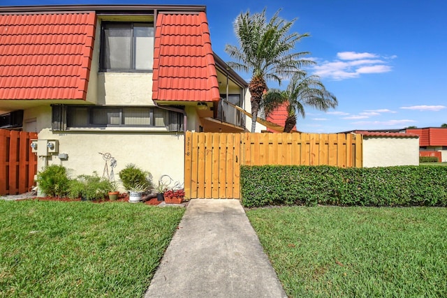 3718 Victoria Dr, West Palm Beach, FL 33406 - view of front of home featuring a tile roof, stucco siding, and a gate