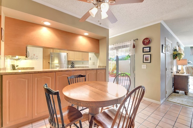 3718 Victoria Dr, West Palm Beach, FL 33406 - dining room with ornamental molding, ceiling fan, light tile patterned flooring, a textured ceiling, and baseboards
