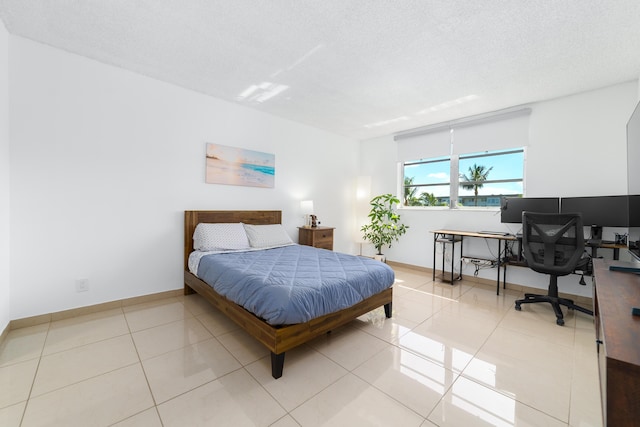 bedroom with baseboards and light tile patterned flooring