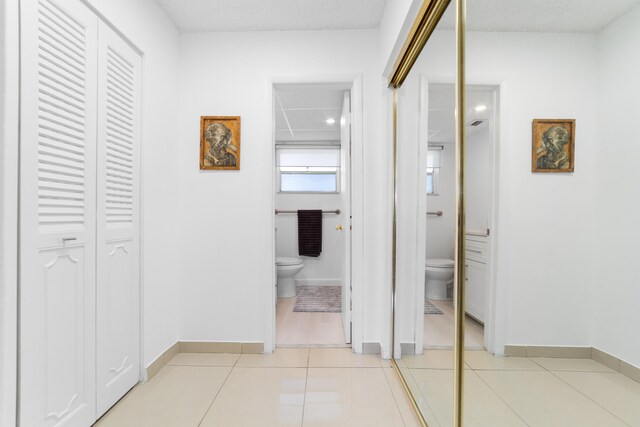 2951 NW 46th Ave Unit 306, Lauderdale Lakes, FL 33313 - corridor with light tile patterned floors and baseboards