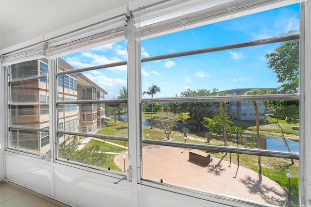 interior space with a water view and tile patterned floors