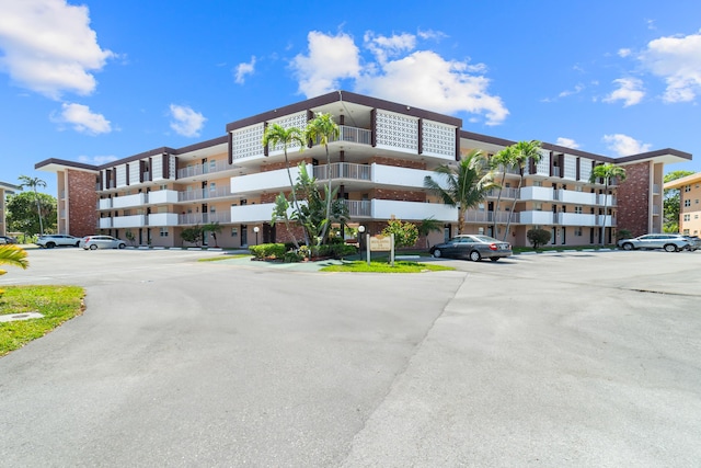 2951 NW 46th Ave Unit 306, Lauderdale Lakes, FL 33313 - view of apartment building / complex featuring uncovered parking