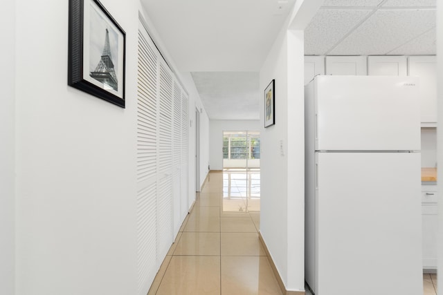 hallway with light tile patterned floors