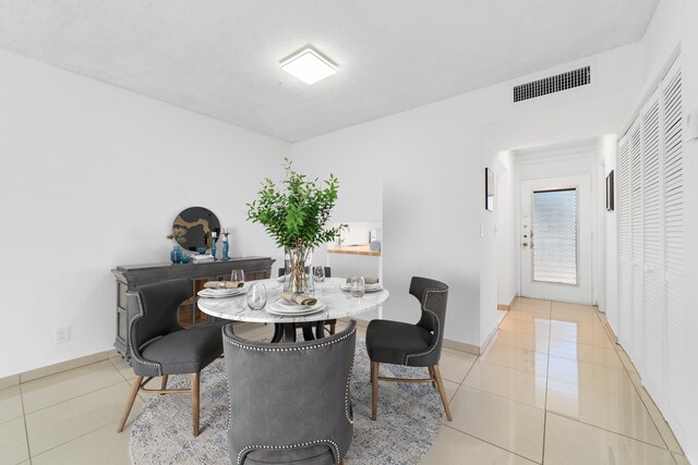 2951 NW 46th Ave Unit 306, Lauderdale Lakes, FL 33313 - dining space featuring light tile patterned floors and baseboards